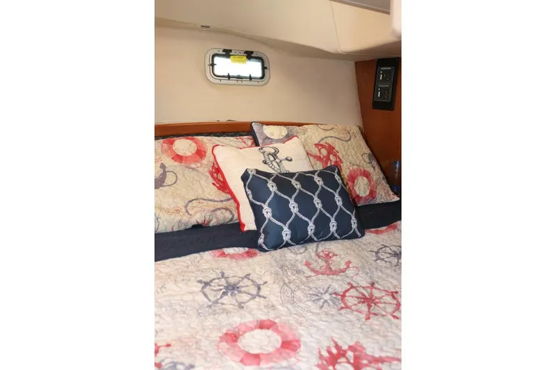 Dolce Vita Yacht Photos Pics Nautical-themed bedding in 2004 Hunter 41 AC cabin, featuring anchor and wheel designs.