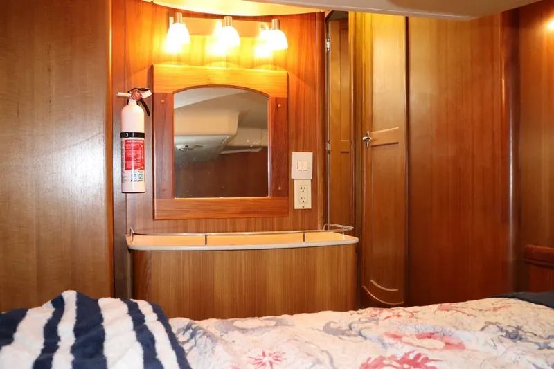 Dolce Vita Yacht Photos Pics Interior of 2004 Hunter 41 AC yacht with wooden cabinetry and mirror.