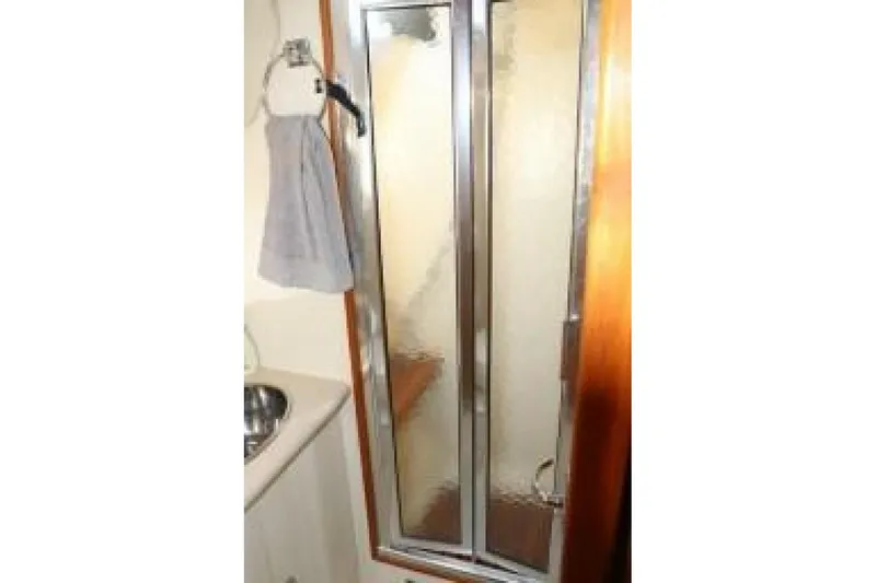 Dolce Vita Yacht Photos Pics Shower area in 2004 Hunter 41 AC yacht bathroom with frosted glass door.