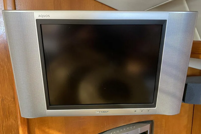 Dolce Vita Yacht Photos Pics Sharp Aquos TV mounted on a wooden panel in a 2004 Hunter 41 AC.