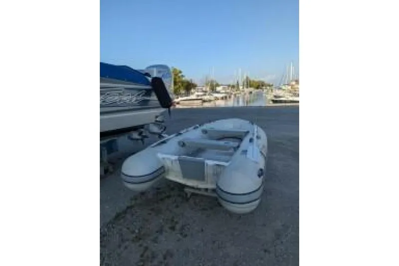 Dolce Vita Yacht Photos Pics Inflatable boat on shore near marina, clear sky, Hunter 41 AC, 2004 model.