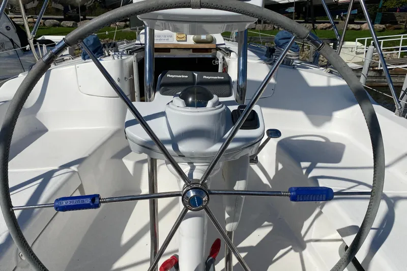 Dolce Vita Yacht Photos Pics Steering wheel of a 2004 Hunter 41 AC sailboat, featuring navigation equipment.
