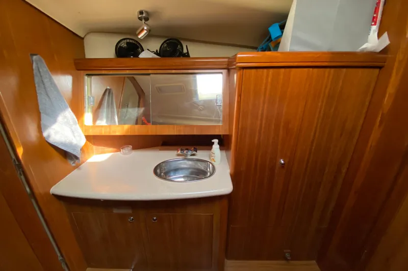 Dolce Vita Yacht Photos Pics 2004 Hunter 41 AC yacht bathroom with wooden cabinetry and sink.