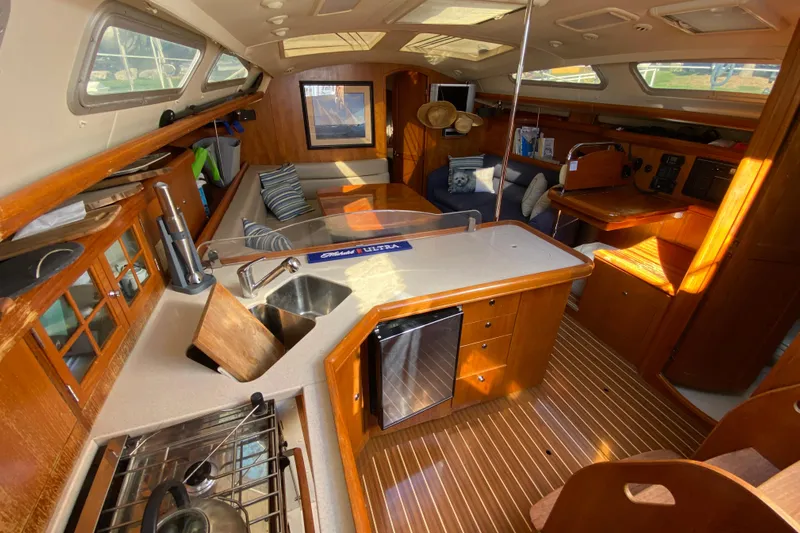 Dolce Vita Yacht Photos Pics Luxurious 2004 Hunter 41 AC yacht interior with modern kitchen and cozy seating area.