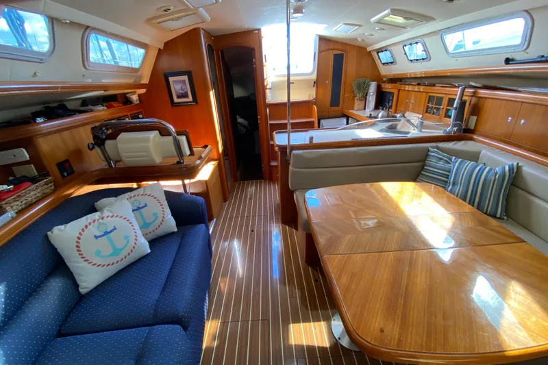 Dolce Vita Yacht Photos Pics Luxurious 2004 Hunter 41 AC yacht interior with wood finish and cozy seating.