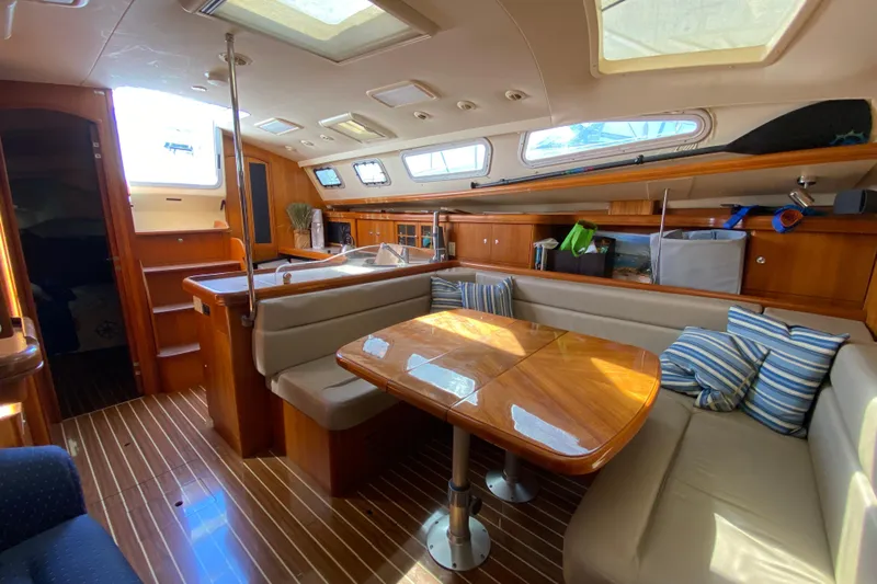 Dolce Vita Yacht Photos Pics Luxurious interior of 2004 Hunter 41 AC yacht with wooden finishes and seating area.