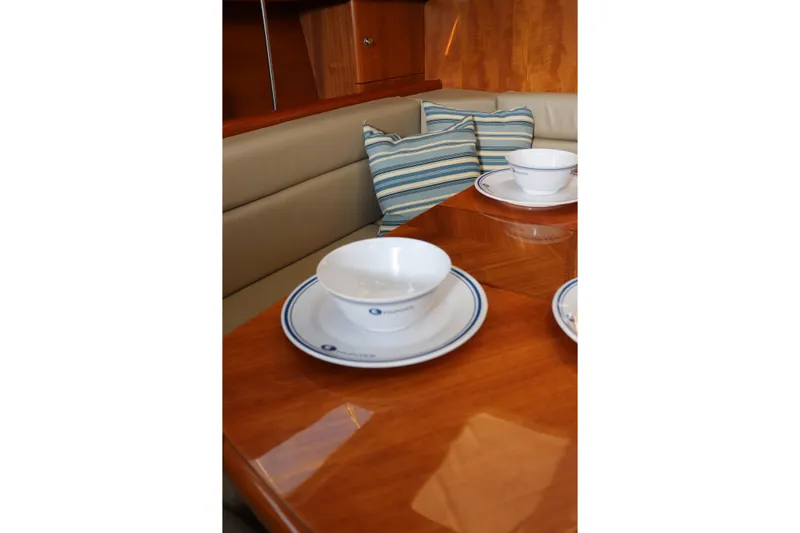 Dolce Vita Yacht Photos Pics Interior of 2004 Hunter 41 AC yacht with dining table and striped cushions.