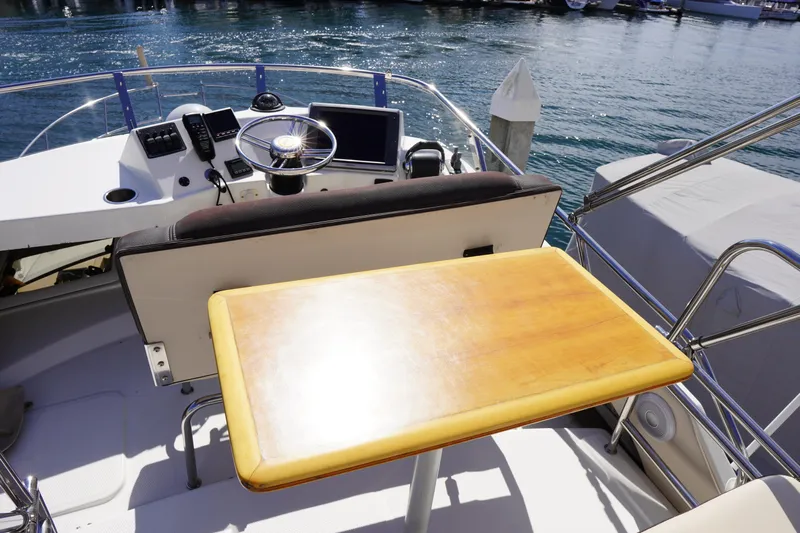E Ticket Yacht Photos Pics 2015 Cutwater 30 Command Bridge helm with wooden table and ocean view.