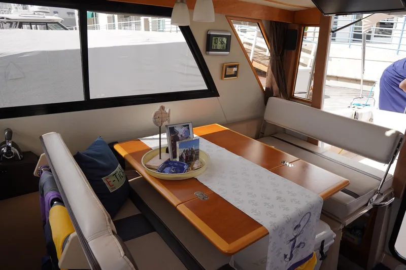 E Ticket Yacht Photos Pics Interior of 2015 Cutwater 30 Command Bridge with dining area and nautical decor.