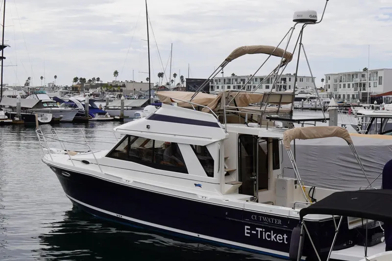 E Ticket Yacht Photos Pics 2015 Cutwater 30 Command Bridge boat docked in a marina.