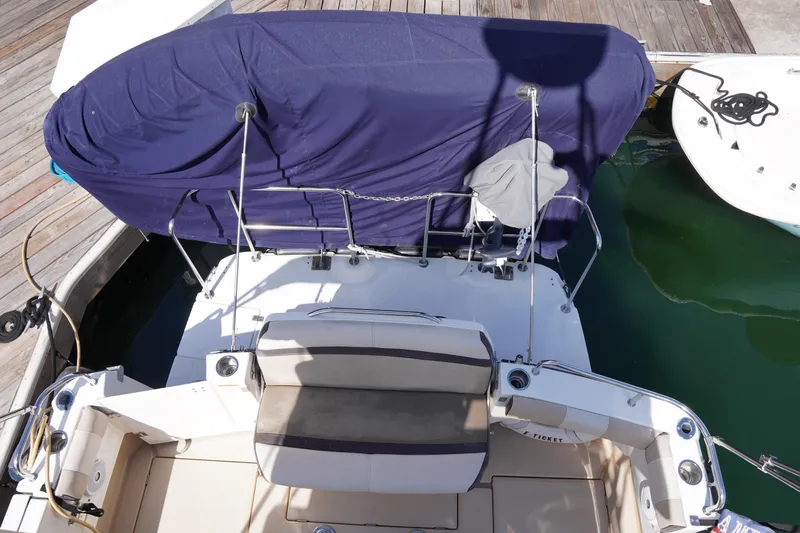 E Ticket Yacht Photos Pics 2015 Cutwater 30 Command Bridge boat docked, covered with a blue tarp.