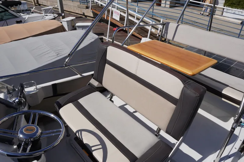 E Ticket Yacht Photos Pics 2015 Cutwater 30 Command Bridge interior with steering wheel and seating area.