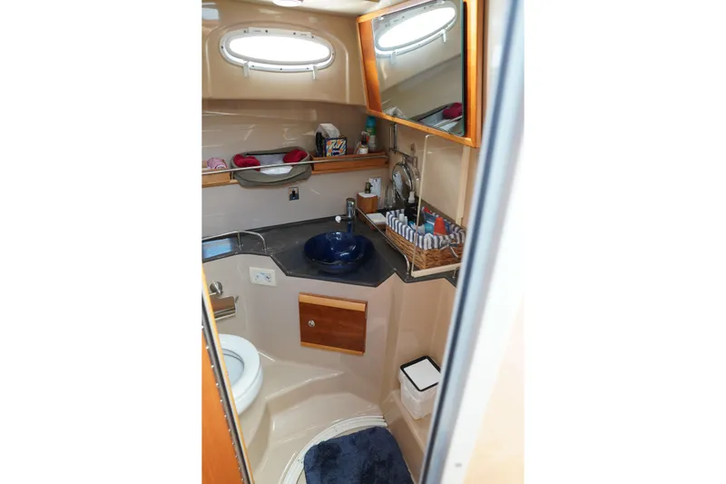E Ticket Yacht Photos Pics 2015 Cutwater 30 Command Bridge bathroom with sink, mirror, and storage.