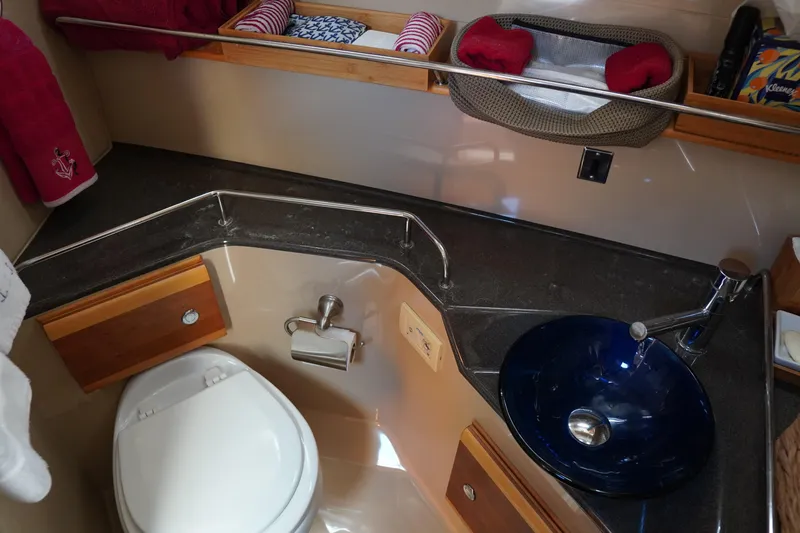 E Ticket Yacht Photos Pics 2015 Cutwater 30 Command Bridge bathroom with modern sink and toilet setup.