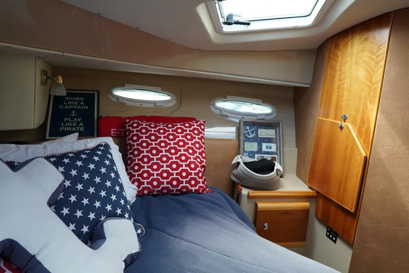 E Ticket Yacht Photos Pics Cozy cabin interior of 2015 Cutwater 30 Command Bridge with nautical decor and bedding.