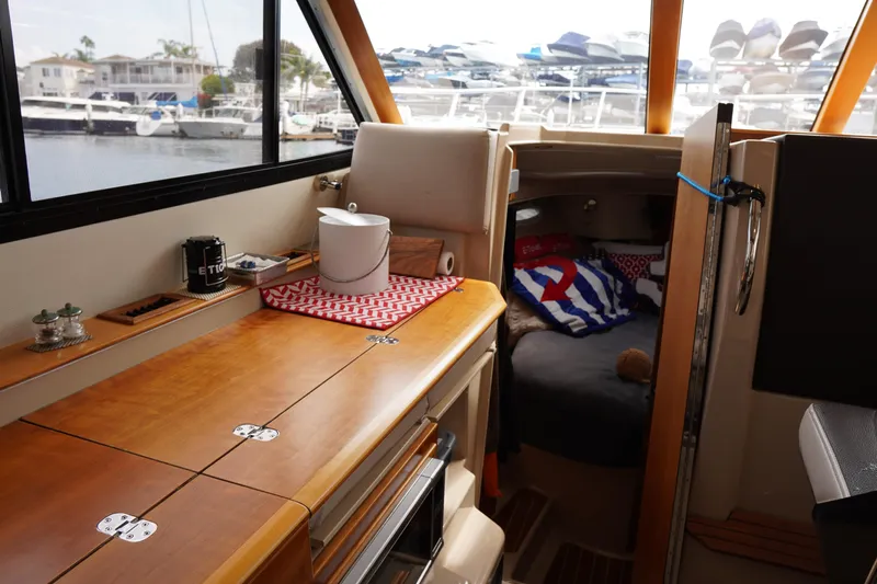 E Ticket Yacht Photos Pics Interior of 2015 Cutwater 30 Command Bridge with cozy cabin and wooden finishes.