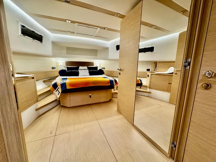 La Doña Yacht Photos Pics Luxurious interior of 2023 Pardo Yachts 50, featuring a modern bedroom with elegant wood finishes.