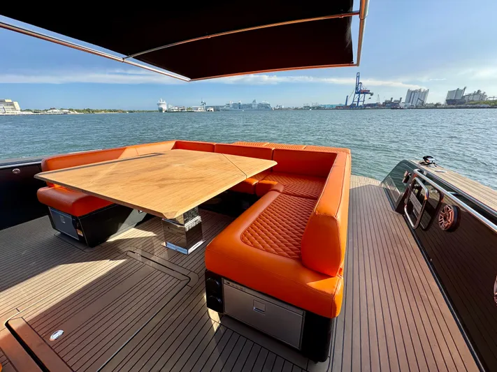 La Doña Yacht Photos Pics Luxury 2023 Pardo Yachts 50 with orange seating and wooden table on deck.