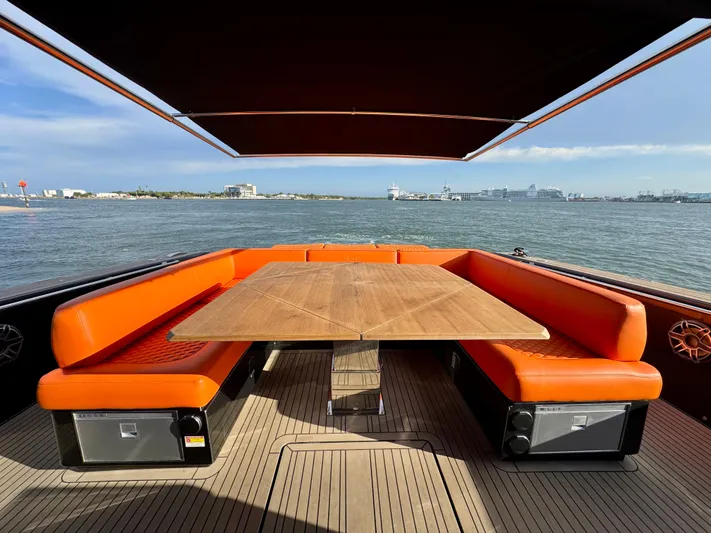 La Doña Yacht Photos Pics Luxury 2023 Pardo Yachts 50 with orange seating and wooden table on deck.