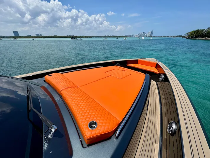 La Doña Yacht Photos Pics 2023 Pardo Yachts 50 with orange sunbed, cruising on clear blue waters.