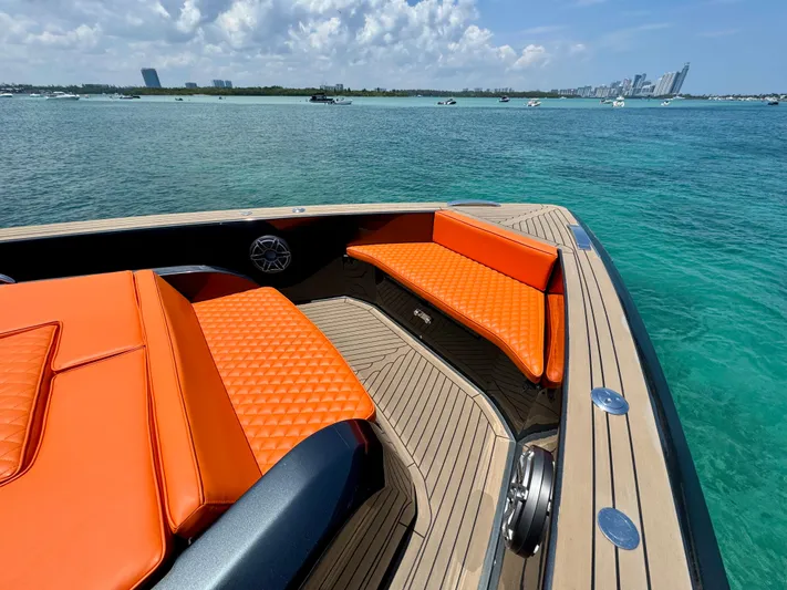 La Doña Yacht Photos Pics Luxurious 2023 Pardo Yachts 50 with vibrant orange seating, cruising on clear blue waters.