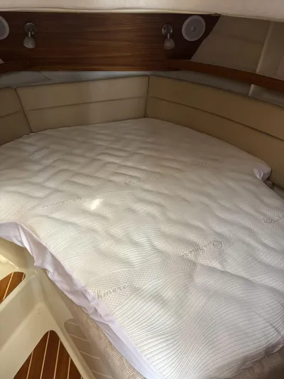  Yacht Photos Pics 2024 Ranger Tugs R31S cabin interior with a cozy bed and wooden accents.