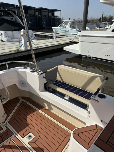  Yacht Photos Pics 2024 Ranger Tugs R31S boat with wooden deck and seating at a marina.
