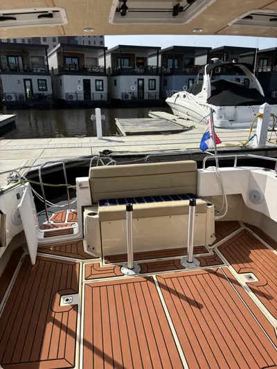  Yacht Photos Pics 2024 Ranger Tugs R31S boat interior with wooden deck, docked at marina.
