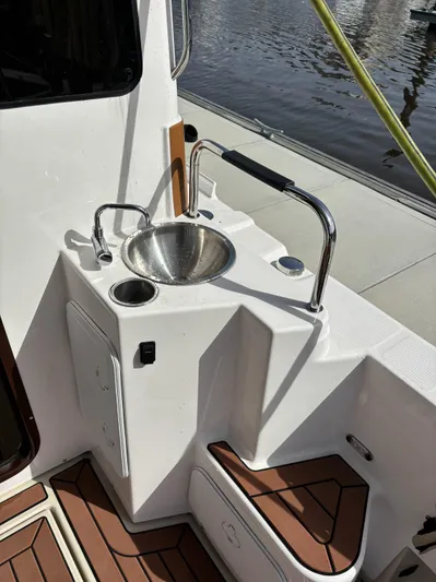  Yacht Photos Pics 2024 Ranger Tugs R31S boat deck with sink and wooden flooring.