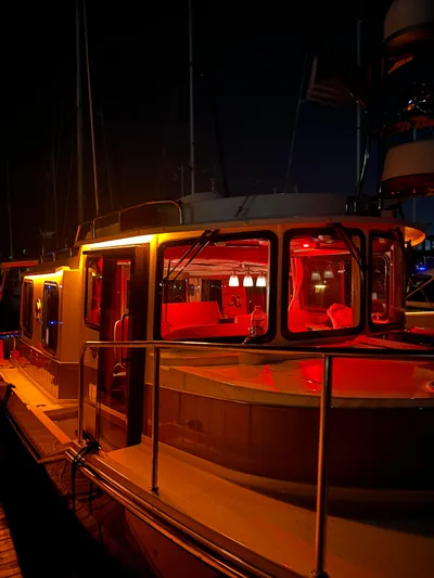  Yacht Photos Pics 2024 Ranger Tugs R31S boat docked at night with warm interior lighting.