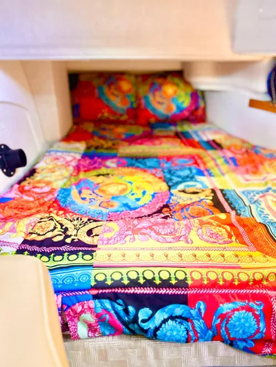  Yacht Photos Pics 2024 Ranger Tugs R31S cabin with vibrant, colorful bedding.