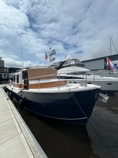  Yacht Photos Pics 2024 Ranger Tugs R31S docked, showcasing sleek design and modern features.