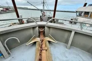 Western Shore Yacht Photos Pics 1989 Custom Expedition boat with anchor on deck, docked in a marina.