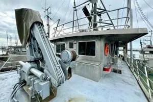 Western Shore Yacht Photos Pics 1989 Custom Expedition boat with crane, docked at a marina under cloudy skies.
