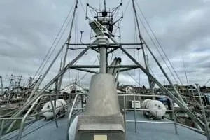 Western Shore Yacht Photos Pics 1989 Custom Expedition vessel with radar and lifeboats, docked under cloudy skies.