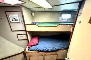 Western Shore Yacht Photos Pics 1989 Custom Expedition cabin with bunk beds, cozy interior, and small window.