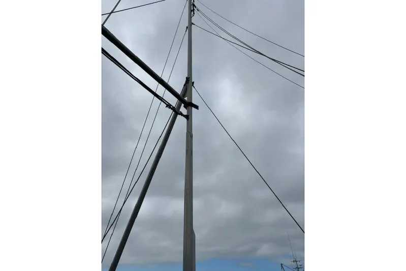 Western Shore Yacht Photos Pics Tall utility pole with wires against a cloudy sky, Custom Expedition 1989.