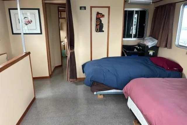 Western Shore Yacht Photos Pics Interior of 1989 Custom Expedition with twin beds, artwork, and window view.