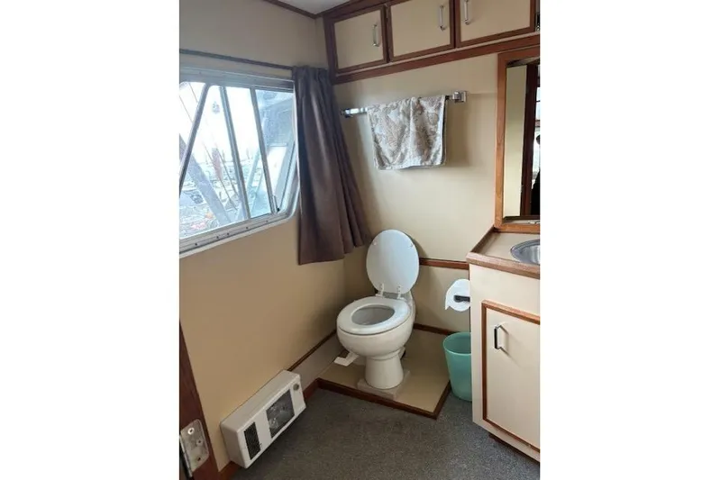 Western Shore Yacht Photos Pics 1989 Custom Expedition bathroom interior with toilet, sink, and window.