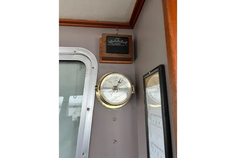Western Shore Yacht Photos Pics Interior of 1989 Custom Expedition with vintage compass and barometer on wall.