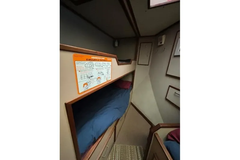 Western Shore Yacht Photos Pics Interior of 1989 Custom Expedition with bunk beds and safety instructions.
