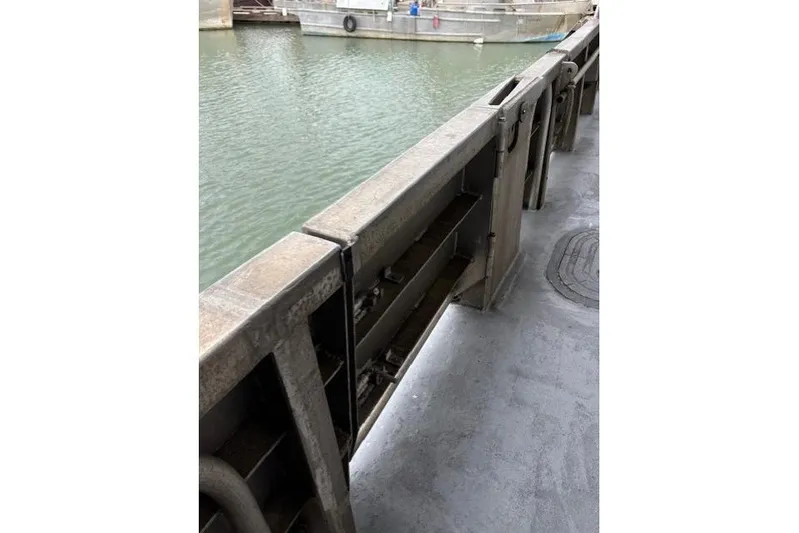 Western Shore Yacht Photos Pics Metal railing on a boat deck overlooking water, Custom Expedition 1989.