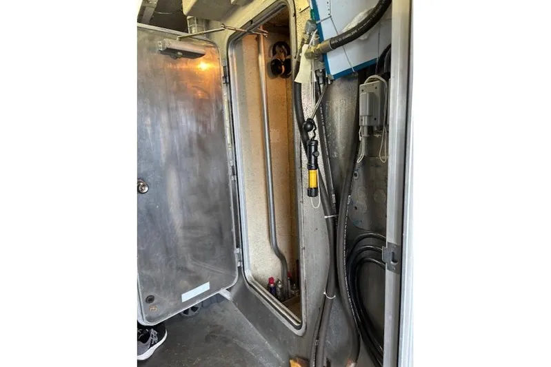 Western Shore Yacht Photos Pics Interior view of a 1989 Custom Expedition vehicle compartment with cables and equipment.