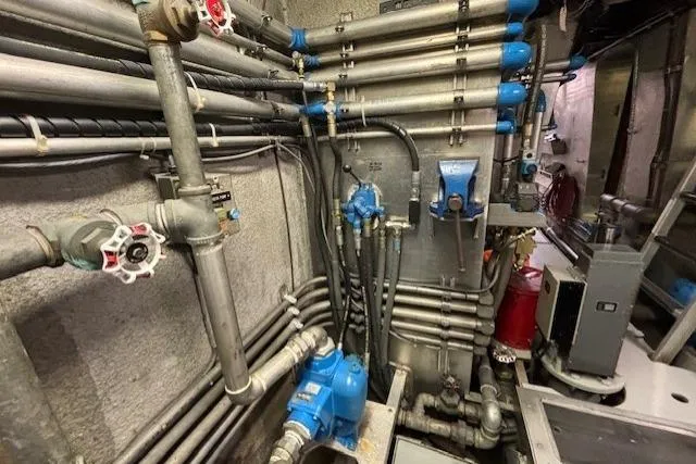Western Shore Yacht Photos Pics Industrial piping system with blue valves and controls in a mechanical room, Custom Expedition 1989.