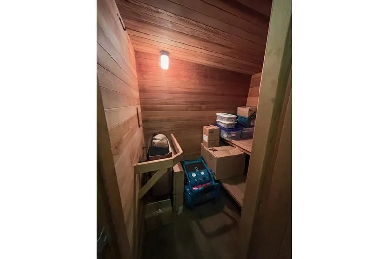 Western Shore Yacht Photos Pics Wooden storage room with boxes and a light, featuring a 1989 Custom Expedition.