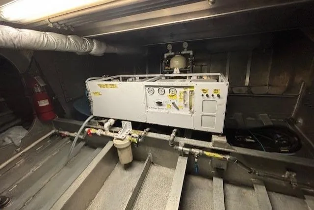 Western Shore Yacht Photos Pics Engine room of a 1989 Custom Expedition with control panel and piping system.