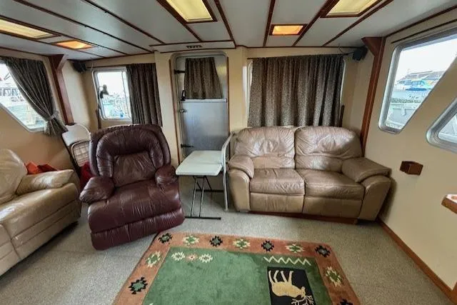 Western Shore Yacht Photos Pics Cozy 1989 Custom Expedition interior with leather seating, table, and decorative rug.