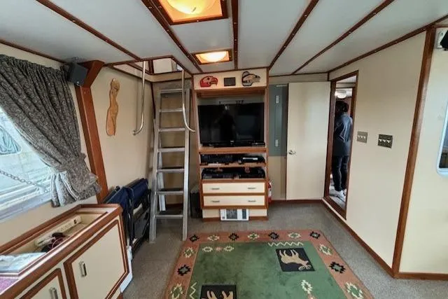 Western Shore Yacht Photos Pics Interior of a 1989 Custom Expedition with cozy decor and entertainment setup.