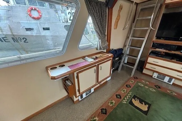 Western Shore Yacht Photos Pics Interior of a 1989 Custom Expedition boat with nautical decor and ladder access.
