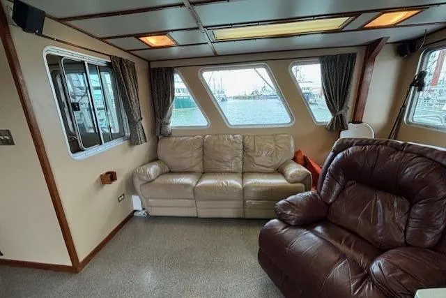 Western Shore Yacht Photos Pics Cozy 1989 Custom Expedition boat interior with leather seating and large windows.